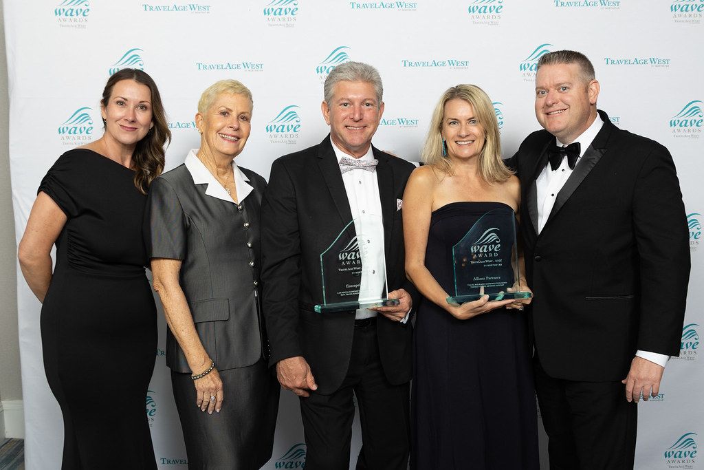 person in blue shirt writing on white paper