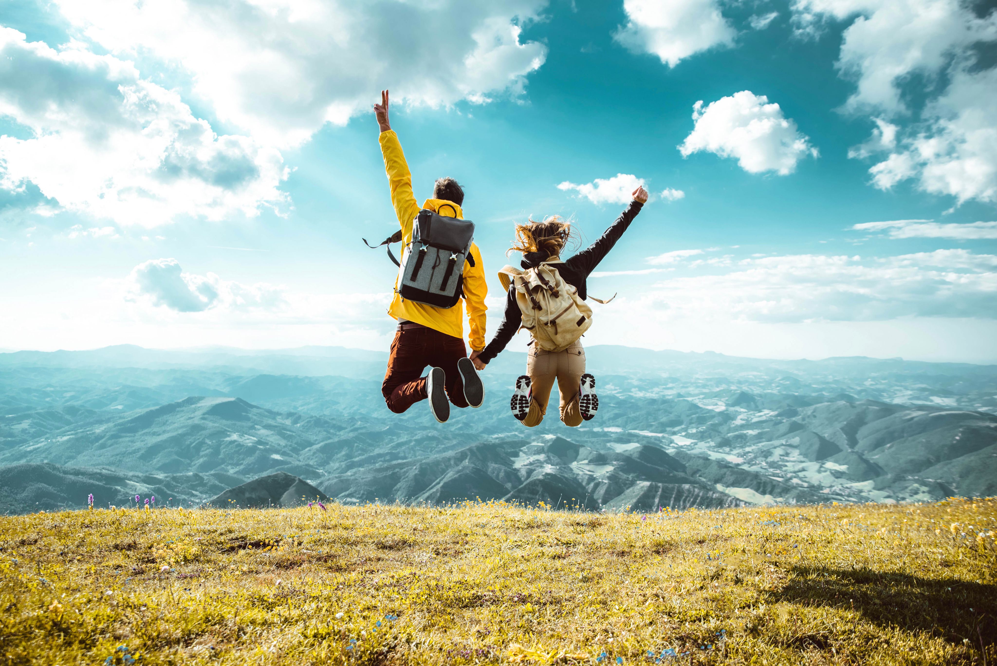 woman jumping towards water wearing life vest